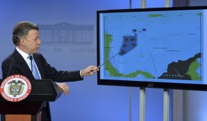 Colombia's President Juan Manuel Santos points to contested waters in the Caribbean seas during his speech in Bogota