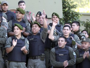 Argentine officers from the National Gendarmerie sing the national anthem during a nationwide protest outside their headquarters in Buenos Aires