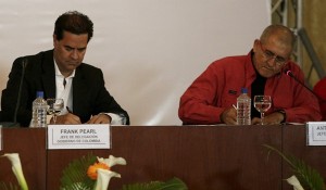 Frank Pearl, head of Colombian government delegation and Antonio Garcia, head of National Liberation Army (ELN) delegation, sign a joint statement to begin formal peace talks in Caracas