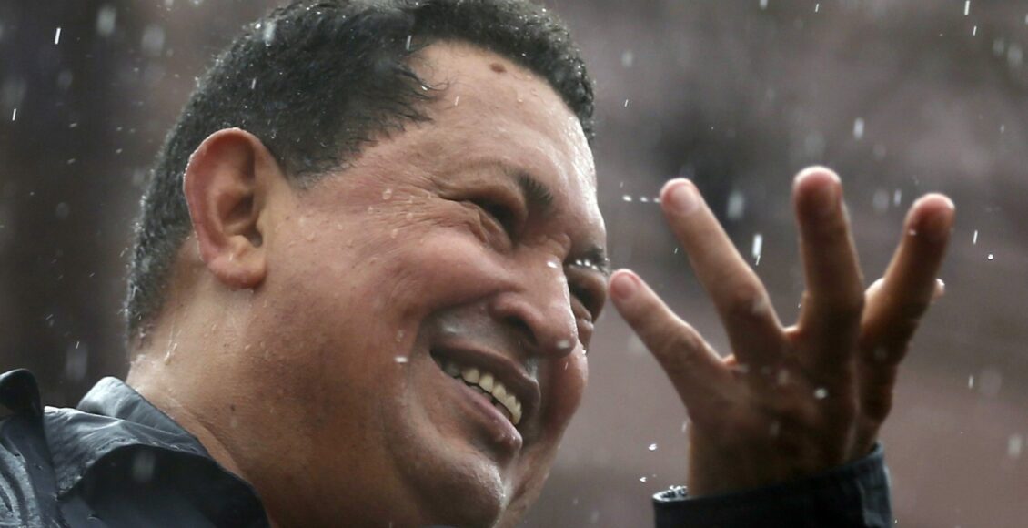Venezuela’s President and presidential candidate Hugo Chavez speaks in the rain during his closing campaign rally in Caracas